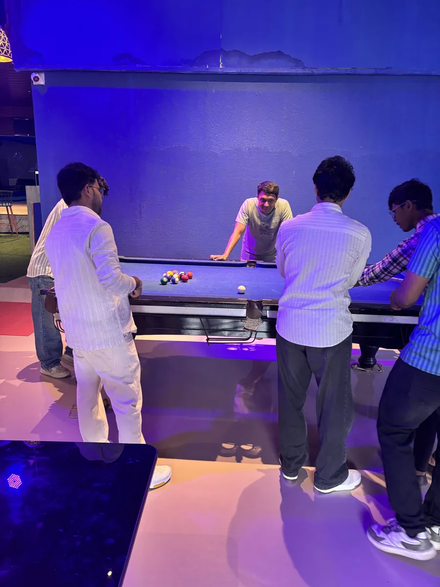 The team playing pool together